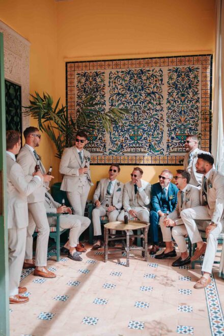 Groomsmen laughing together before ceremony at Hacienda Villa Luisa wedding Seville