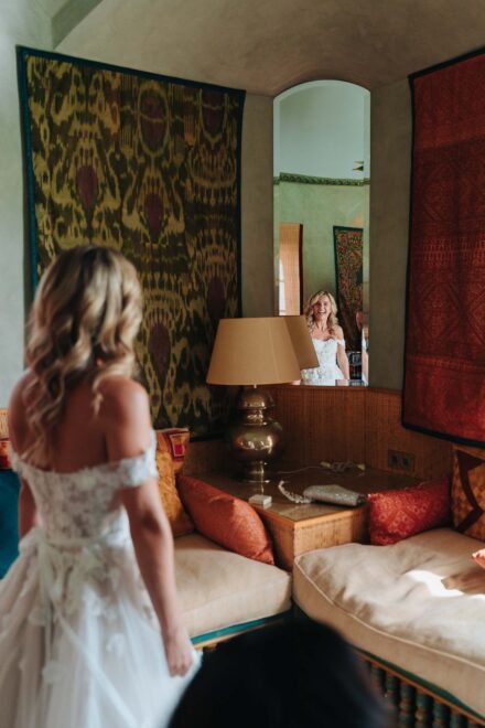 Bride looking at herself in mirror before ceremony at Hacienda Villa Luisa wedding Seville