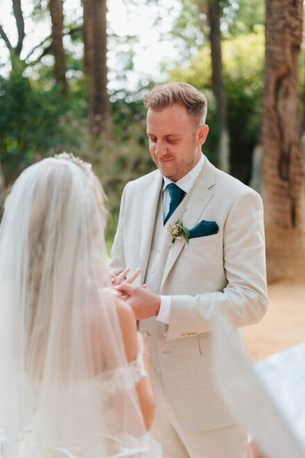 bride and groom exchanging rings during outdoor wedding ceremony in seville