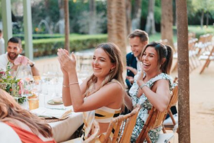 Candid wedding guest moment during dinner in Seville