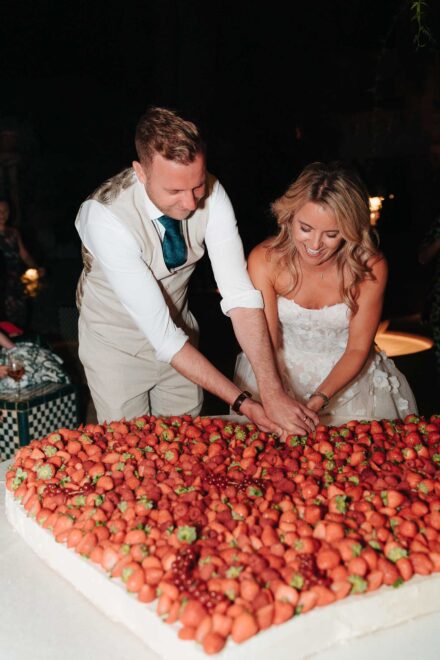 Wedding cake cutting with strawberries in Seville