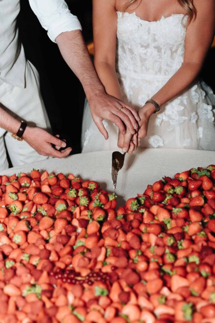 Wedding cake cutting with strawberries in Seville
