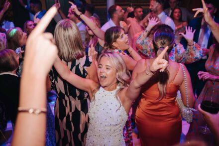 bride dancing on the floor surrounded by guests and party lights during wedding reception in Seville
