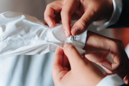 Close-up of groom cufflinks with the initials P&L while getting ready before a wedding in Seville