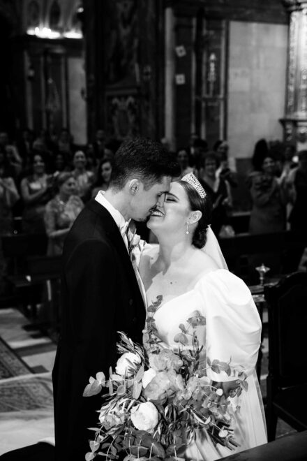 Bride and groom sharing an intimate moment during their wedding ceremony at Basilica de la Macarena in Seville