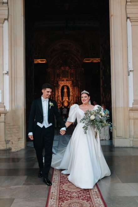Bride and groom leaving Basilica de la Macarena after their wedding ceremony in Seville