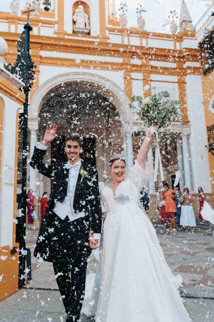 Bride and groom leaving Basilica de la Macarena after their wedding ceremony in Seville