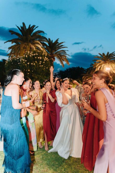 Bride celebrating with friends during the outdoor wedding reception at Castillo de la Monclova in Seville.