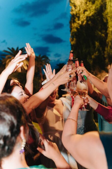 Bride celebrating with friends during the outdoor wedding reception at Castillo de la Monclova in Seville.