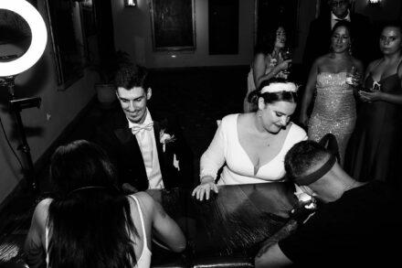 Bride winking while getting a tattoo during wedding celebration in Seville